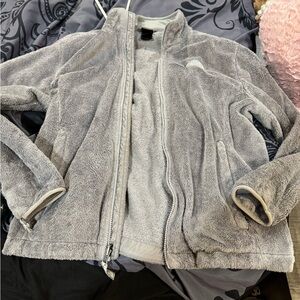 The North Face Women's Light Gray Teddy Jacket has 2 small burn like marks